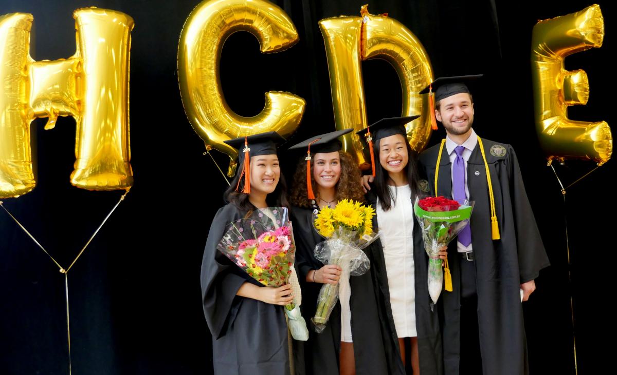 Students posing with HCDE baloons at the 2019 graduation