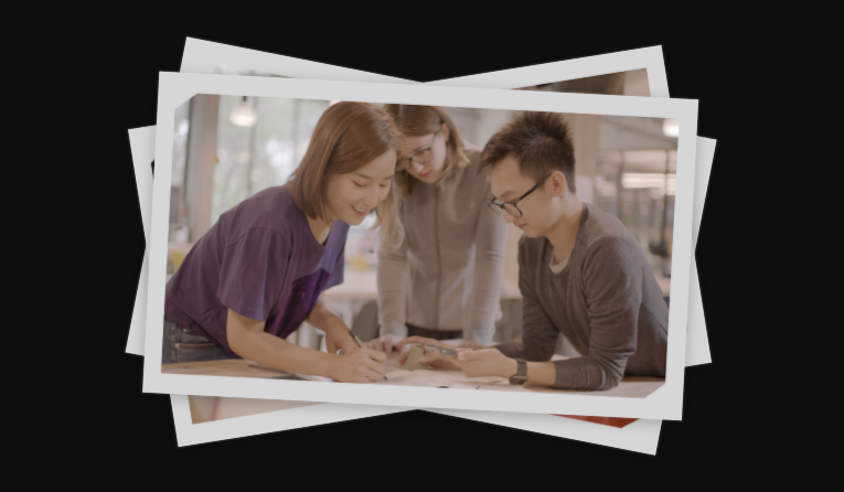 Polaroid photo of three students working