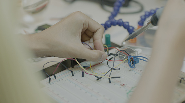Hands working with soldering tool
