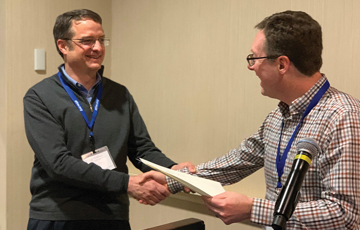 Mark receiving award