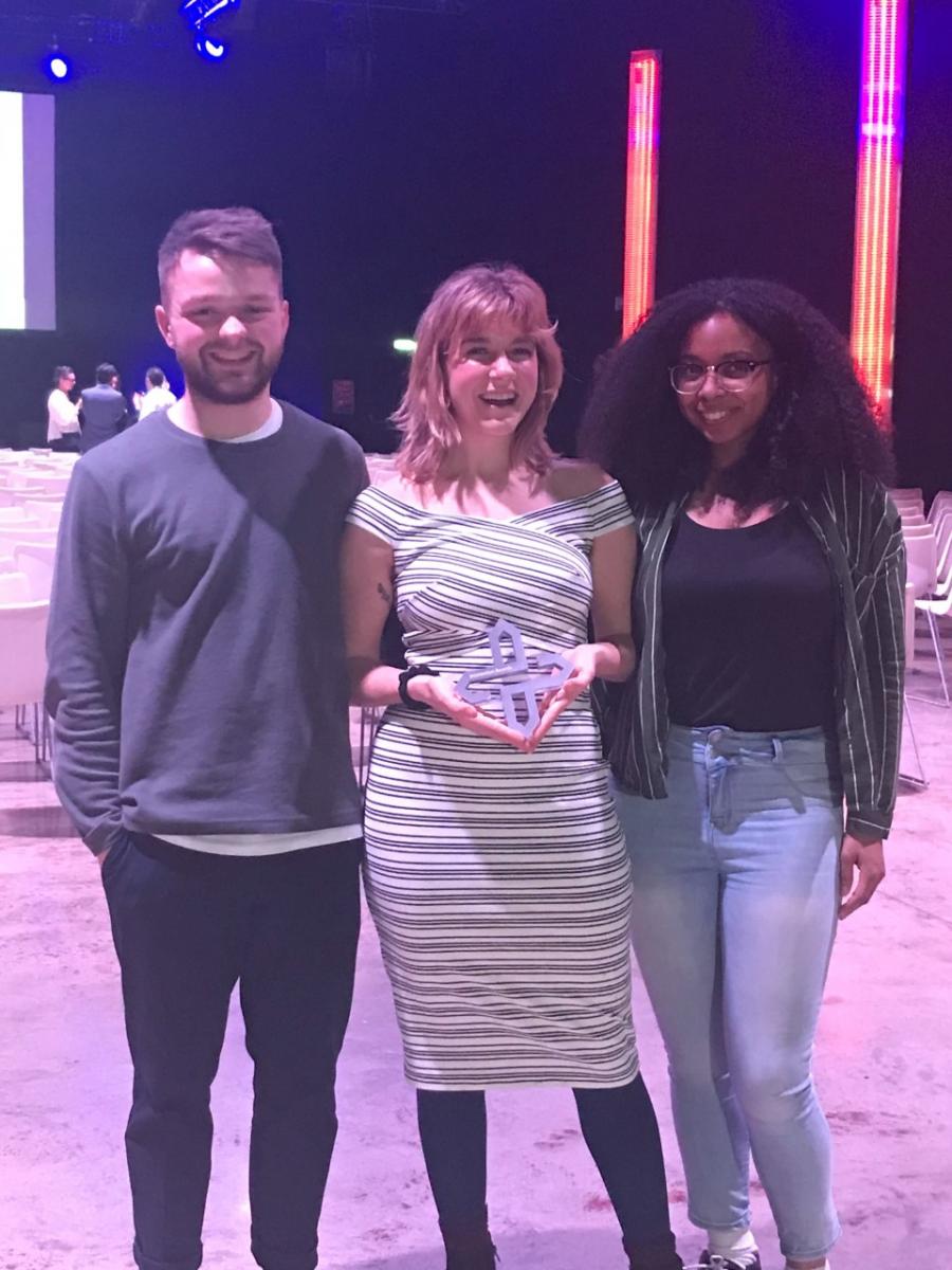 Elisabeth Dunn and teammates holding award at IXDA