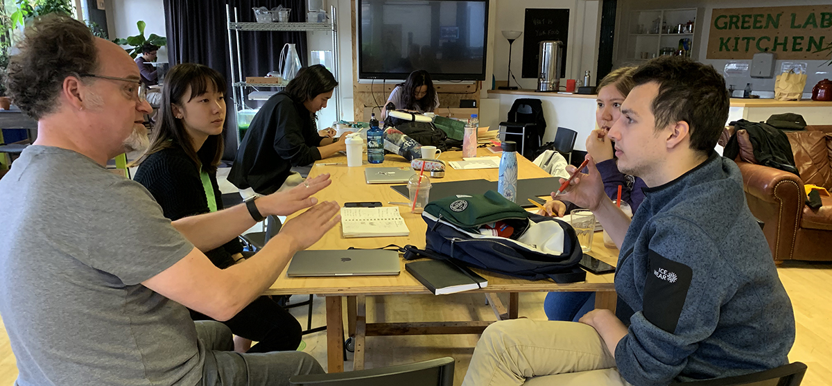 Brock Craft working with students around a table