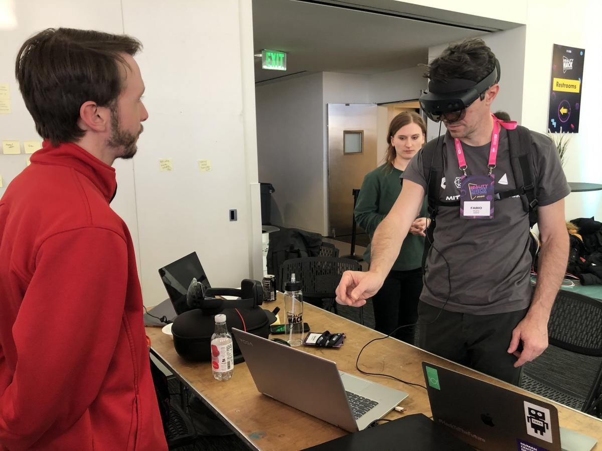 Person with VR headset pinching something in the air