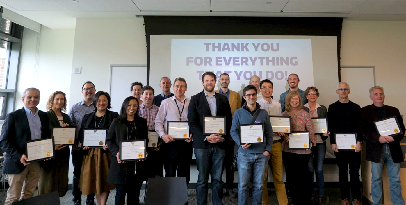 Faculty members holding their awards