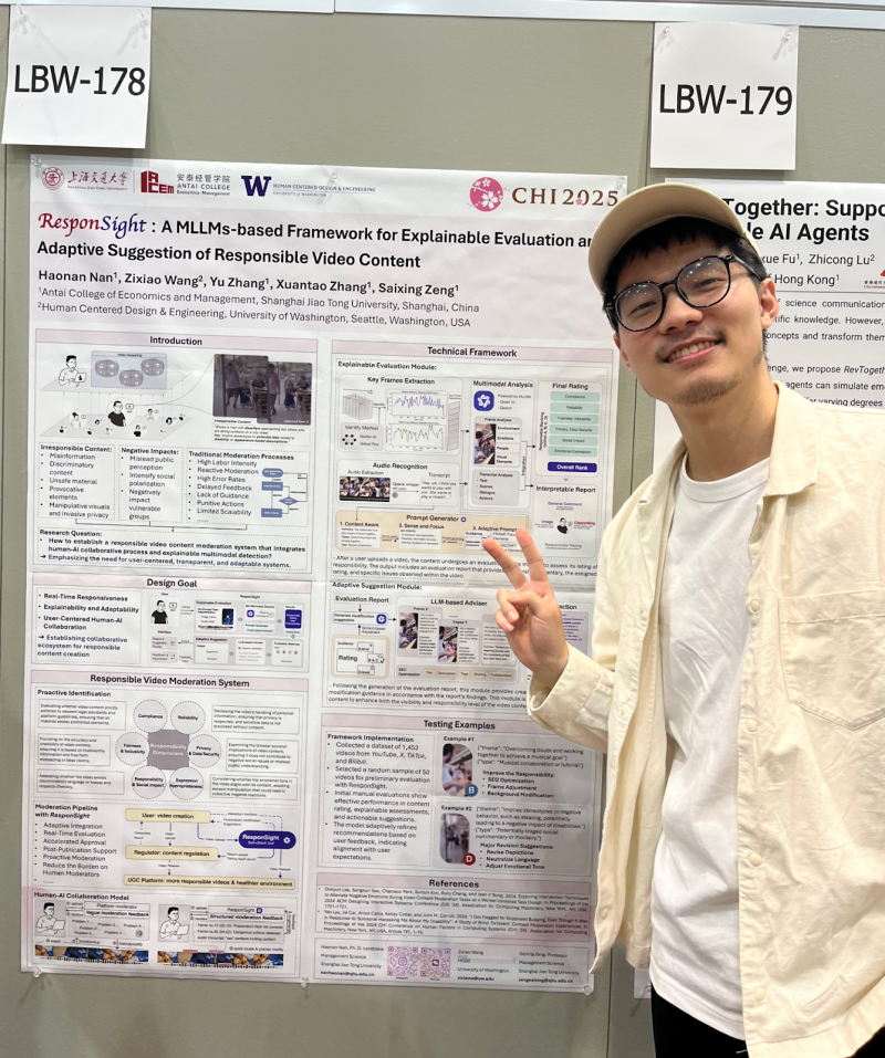 Zack Wang holds a peace sign up in front of their poster