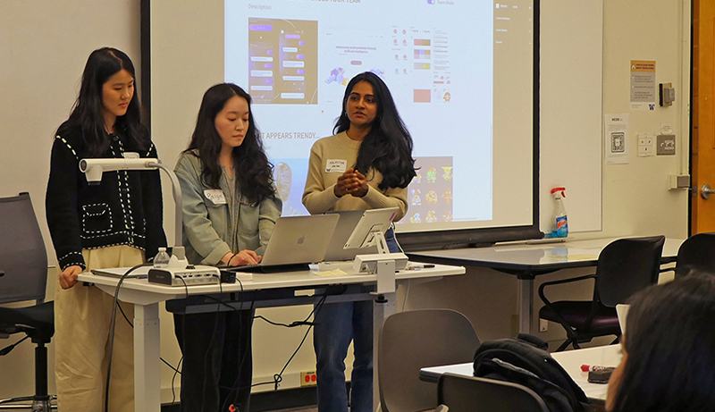 students presenting in front of HCDE classroom