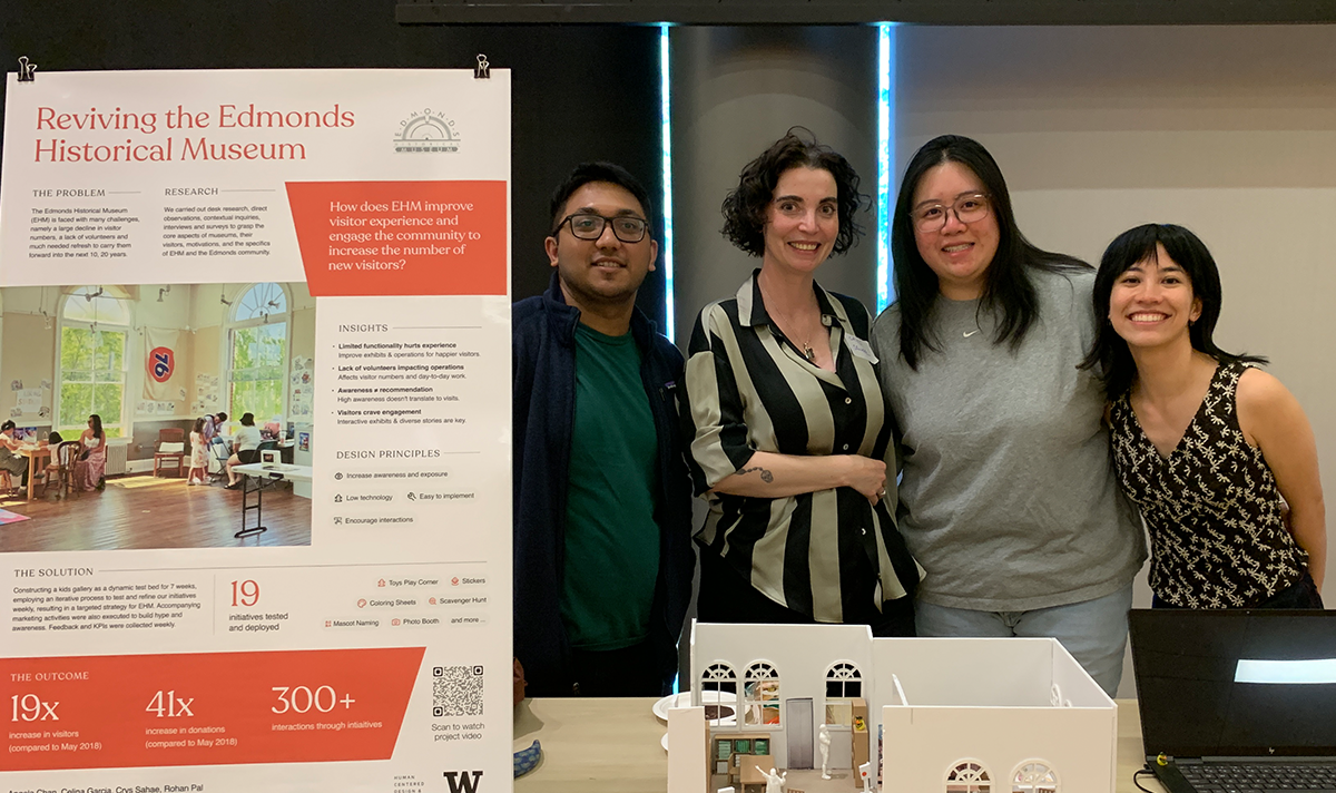 Team of capstone students pose with their poster about redesigning the Edmonds Historical Society