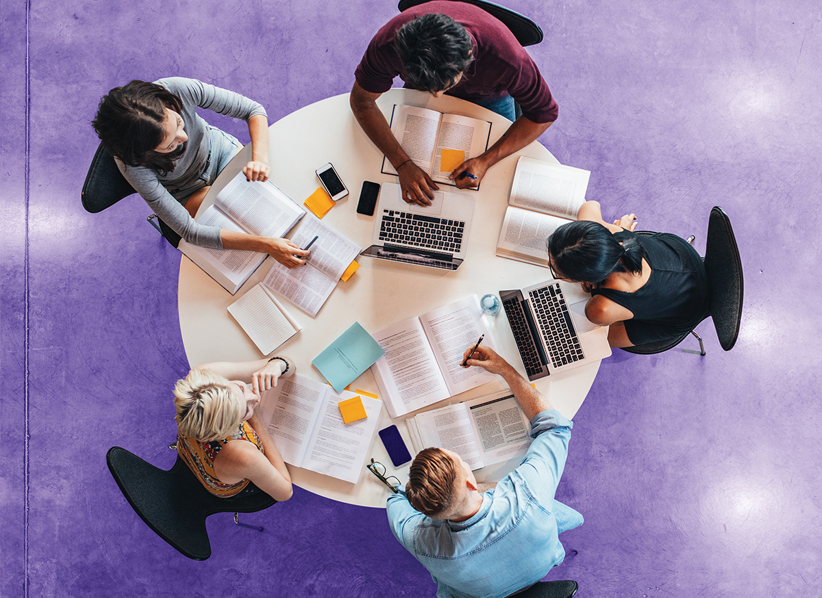 Aerial view of five people working around a table