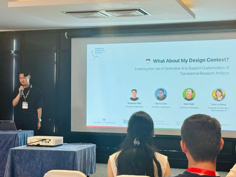 Donghoon stands behind a podium presenting at DIS