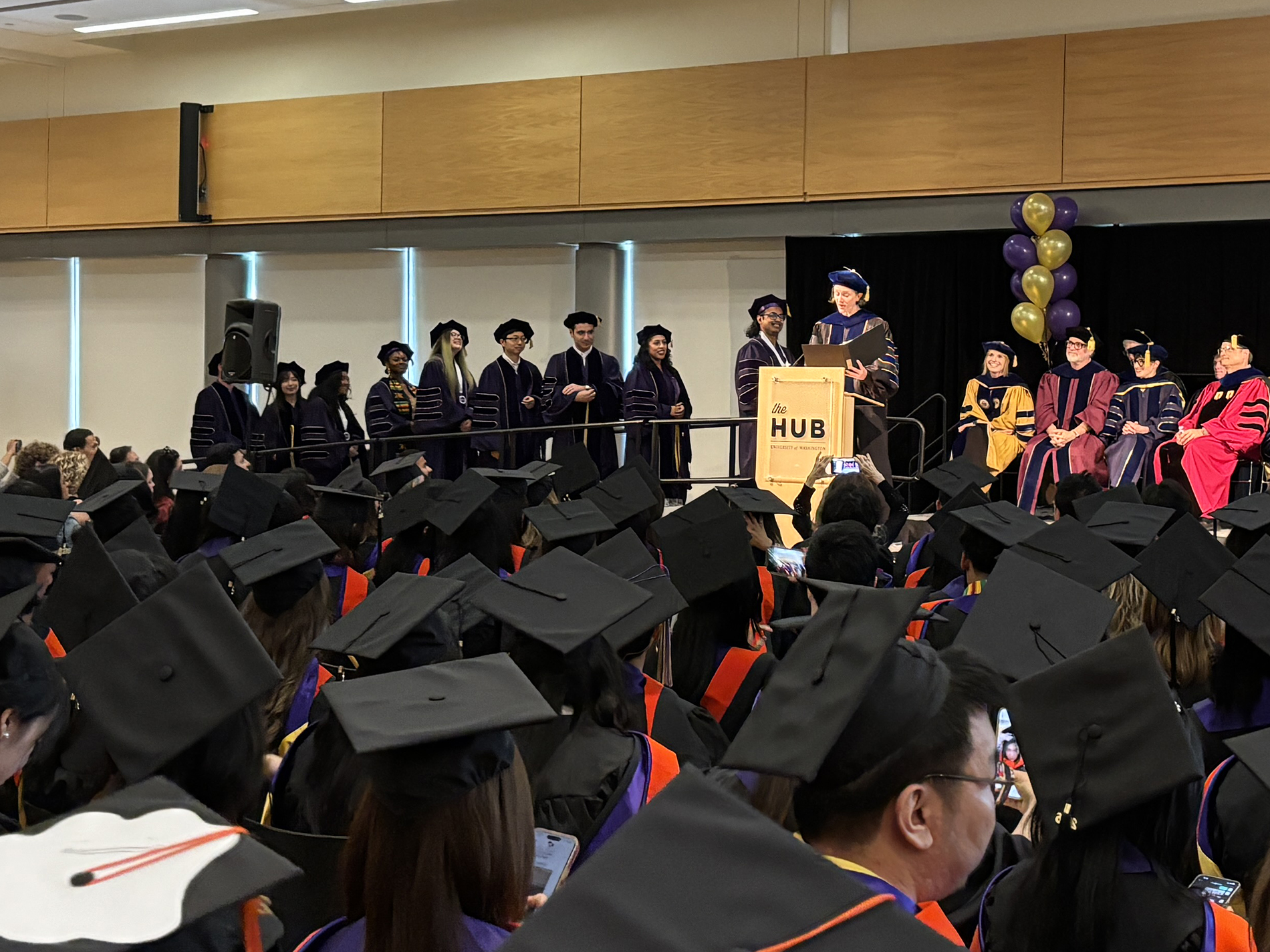 PhD students line up while Kate Starbird presents at the podium