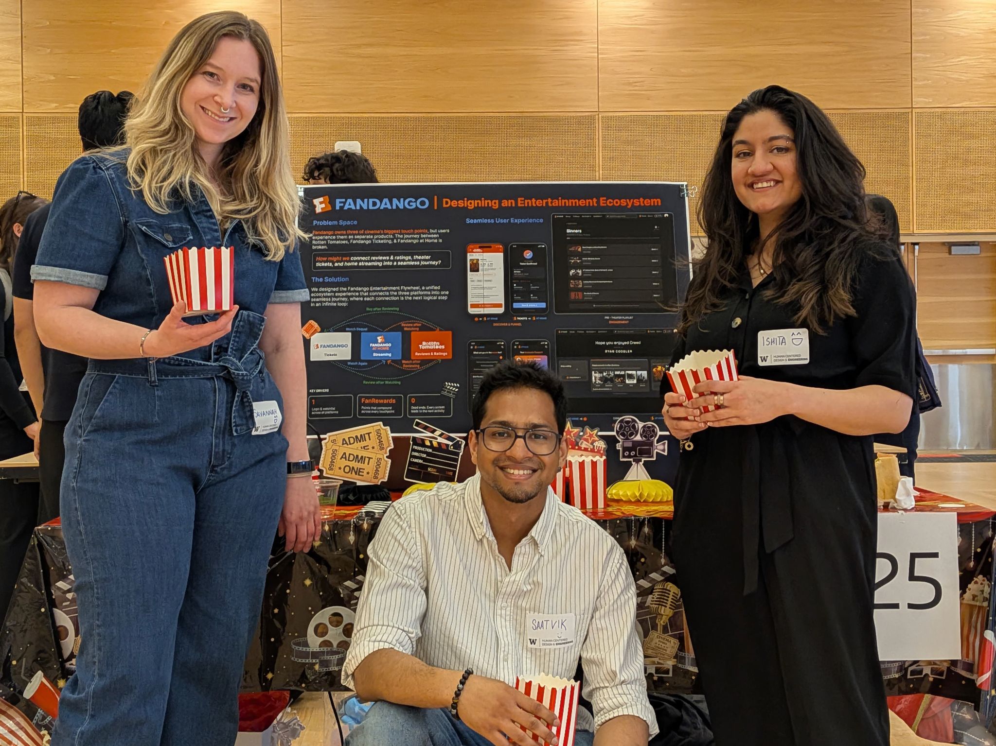 A team of students stand with their capstone display
