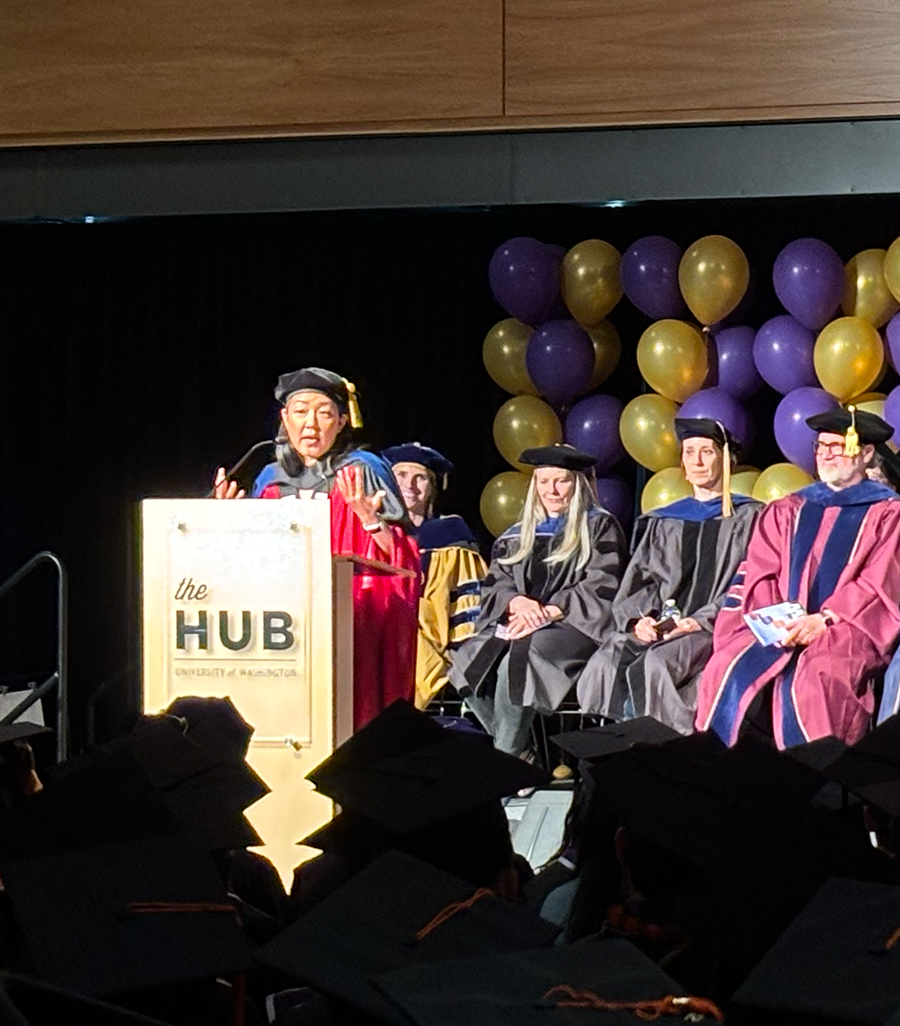 Leila Takayama delivers speech behind podium at the HCDE Graduation Ceremnony