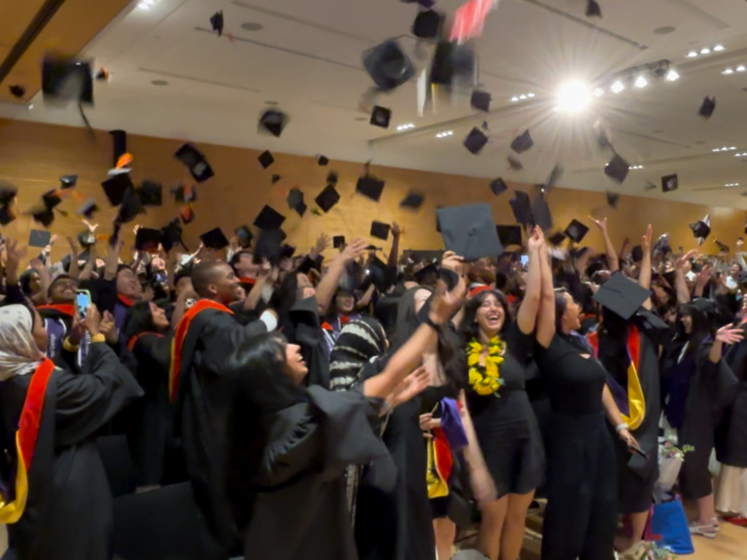 Graduates tossing their hats in the air