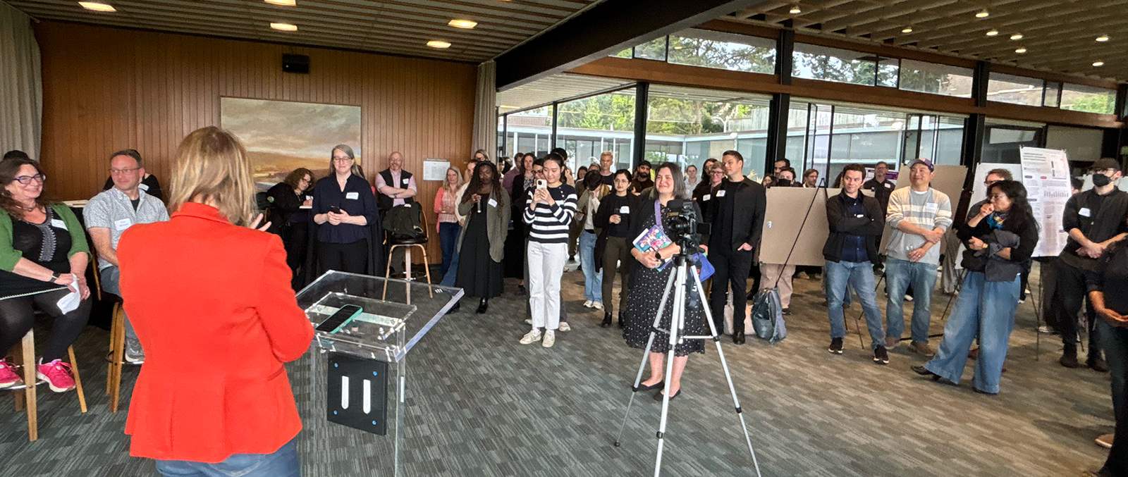 Professor Julie Kientz speaks to attendees from the podium
