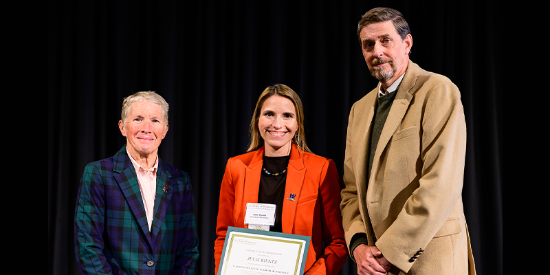 Julie accepts framed certificate at WSAS event