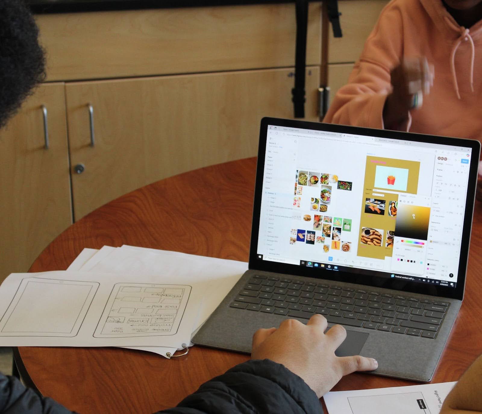 close up of a laptop screen where a younger student works on Figma