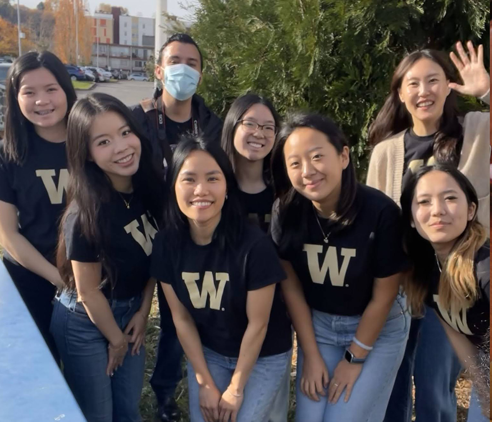 eight HCDE students in UW t-shirts pose together at an outreach event