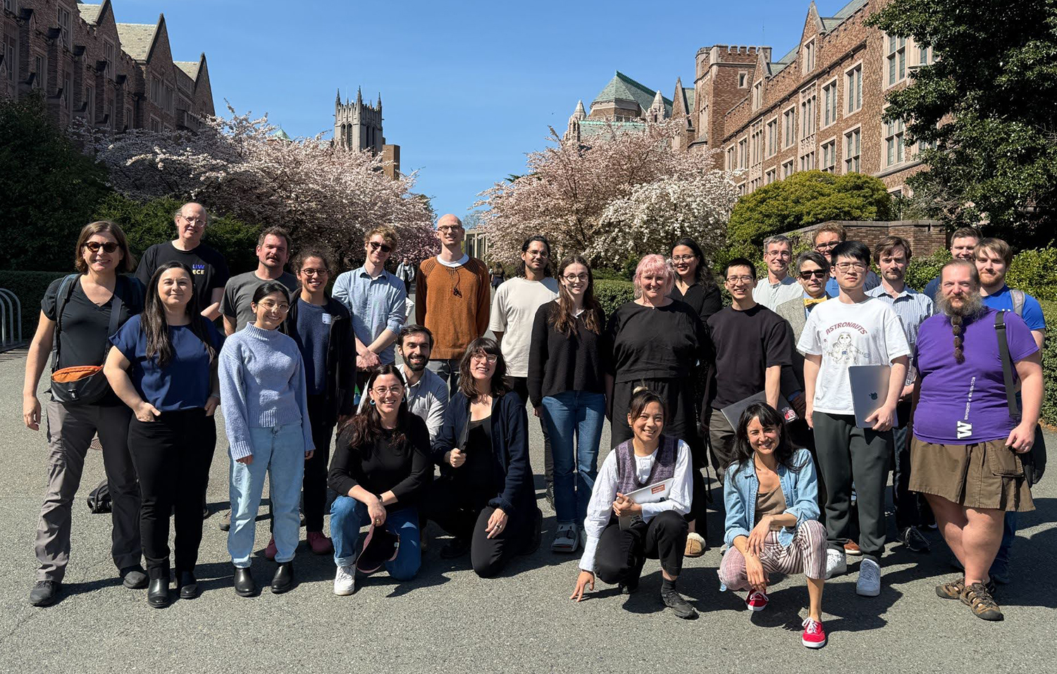 Group of about 30 workshop participants, including Nadya Peek, stand outside at UW with campus buildings in the background