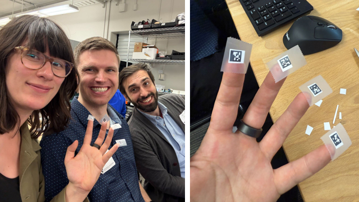 Nadya poses with two other workshop participants and miniature QR codes are taped to her fingers