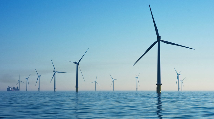 A dozen wind turbines over open water
