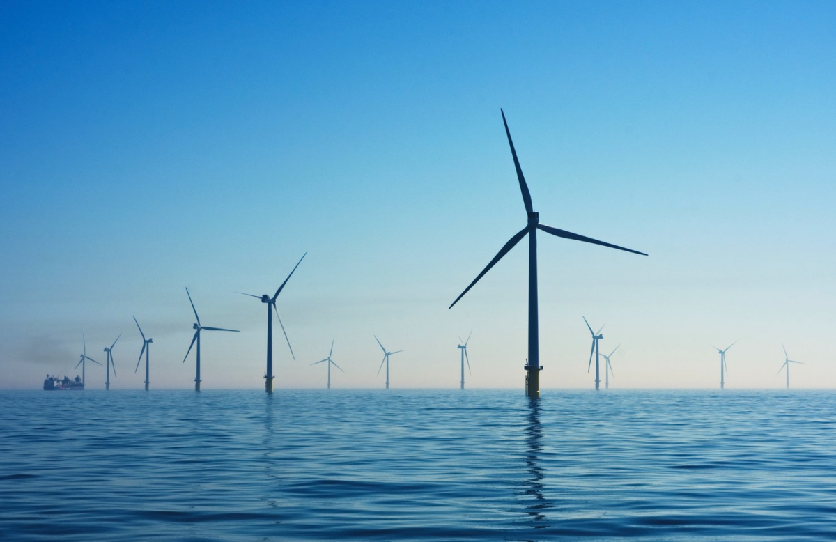 A dozen wind turbines over water