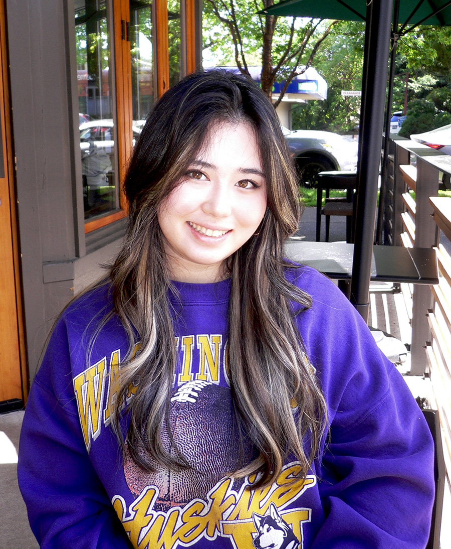 Taylor Bradshaw wears a UW sweatshirt and smiles at the camera