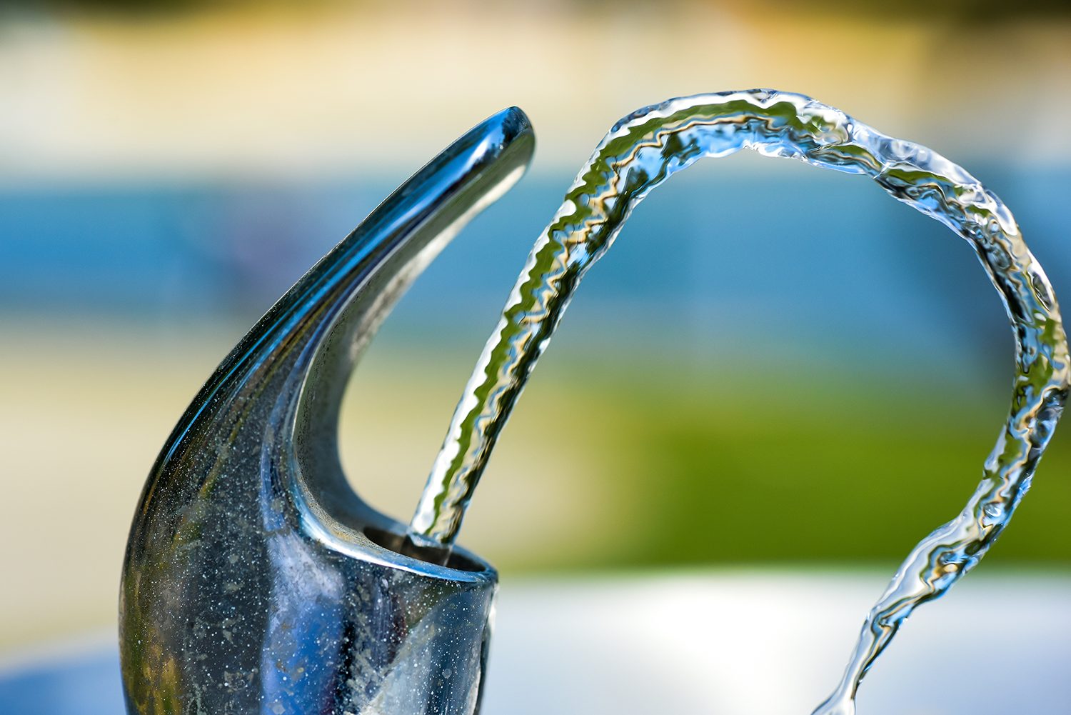 Drinking fountain with water spouting out.
