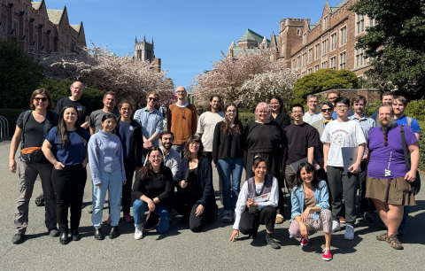 Group of about 30 workshop participants, including Nadya Peek, stand outside at UW with campus buildings in the background
