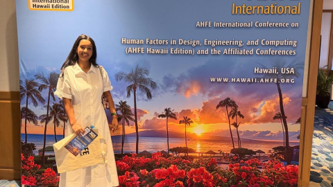 Tasnim stands in front a the AHFE poster