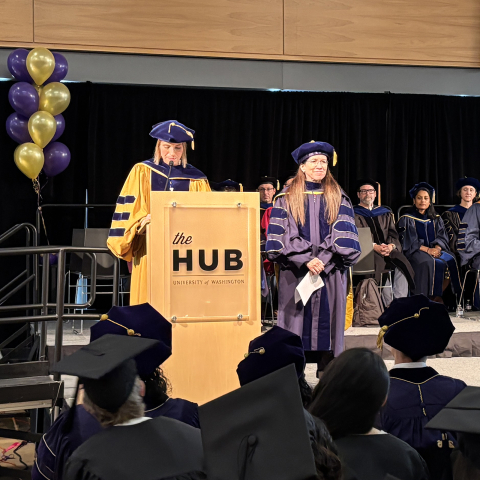 Cecilia Aragon stands with Julie Kientz on stage at the HCDE Graduation Ceremnony
