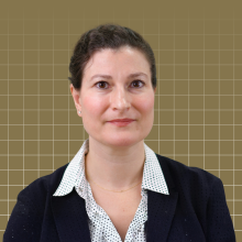 Laura Forlano's headshot over a gold background with a grid pattern.