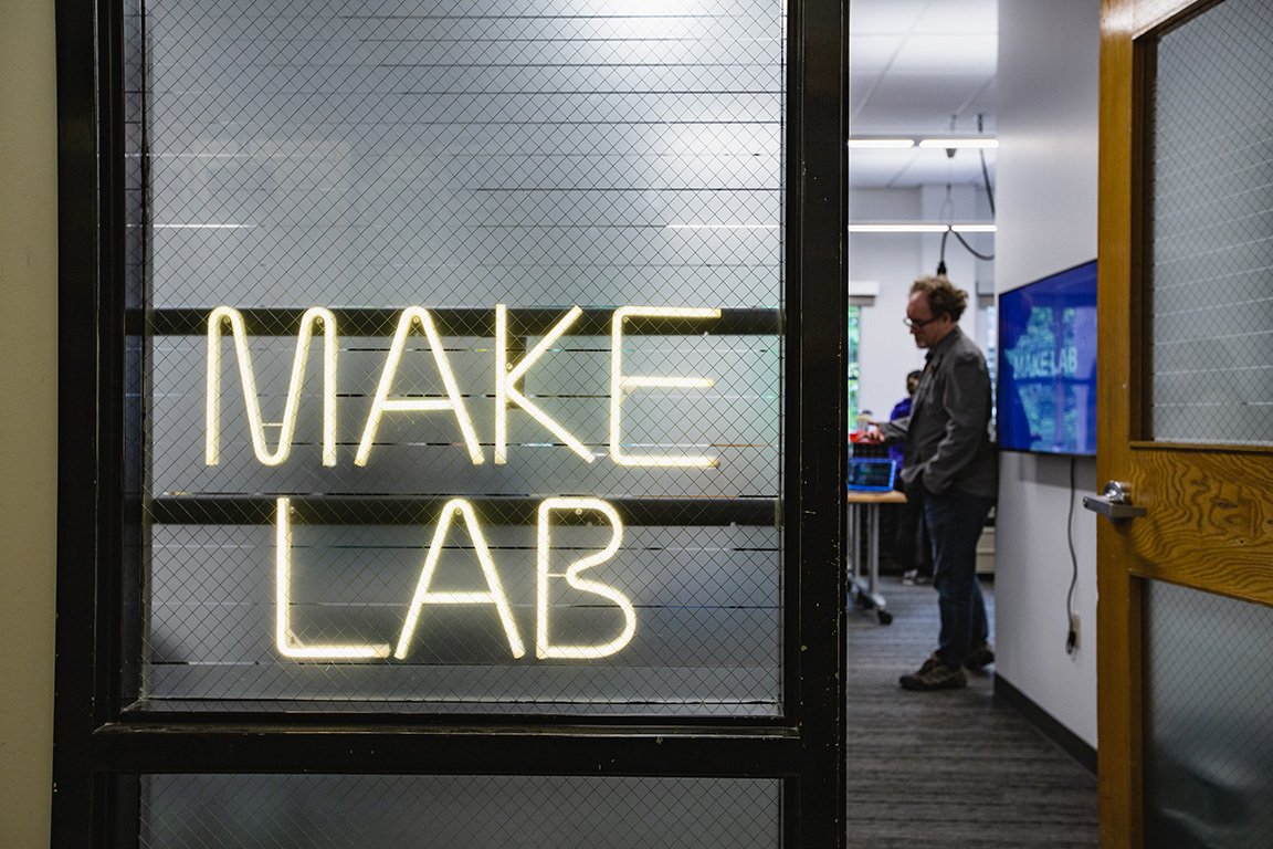 View from the hallway with lighted Make Lab sign in window