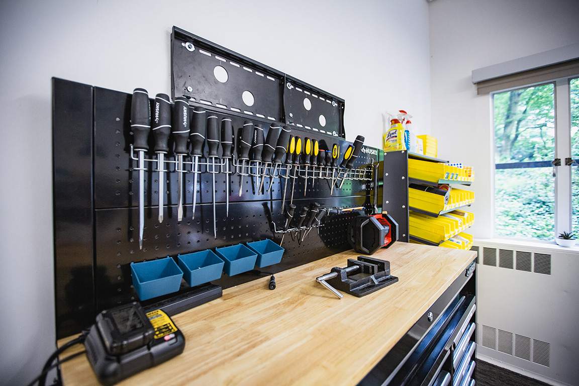 Screw drivers and other tools on the wall and cabinet