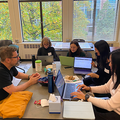 Students working around a table in Sieg Building