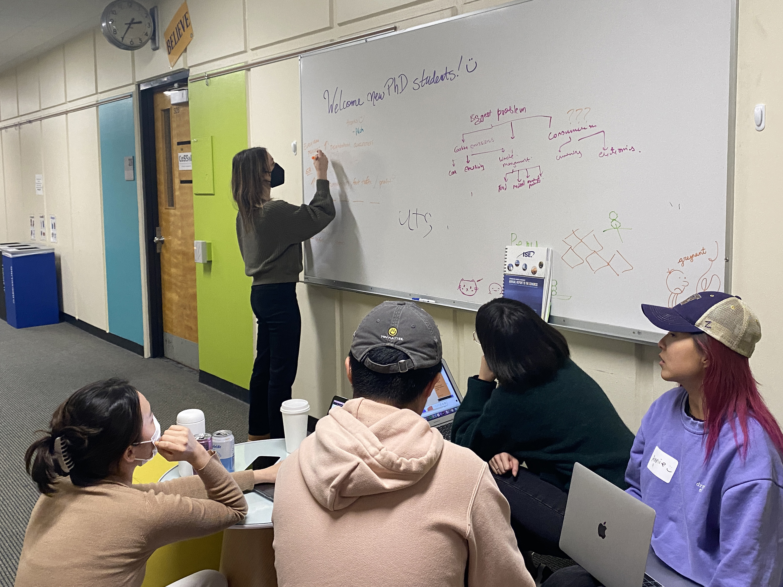 Students working on a whiteboard in Sieg Building