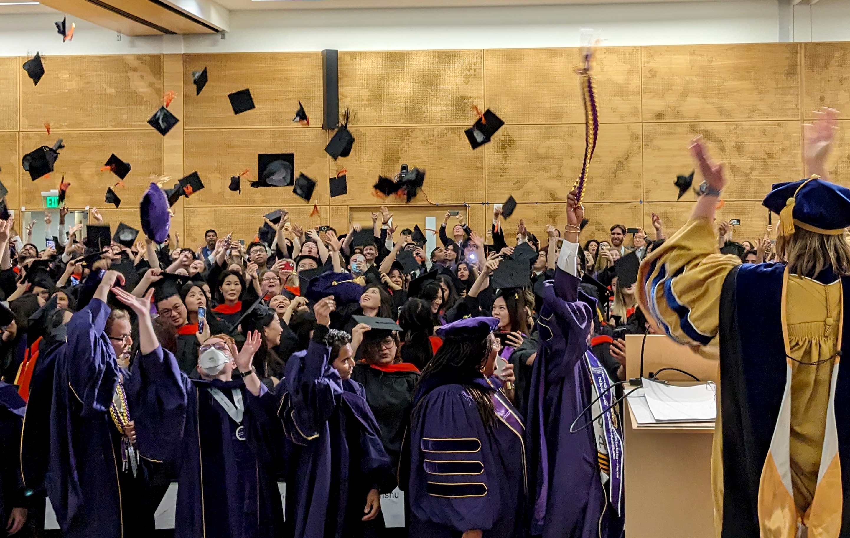 Graduates tossing their hats in the audience