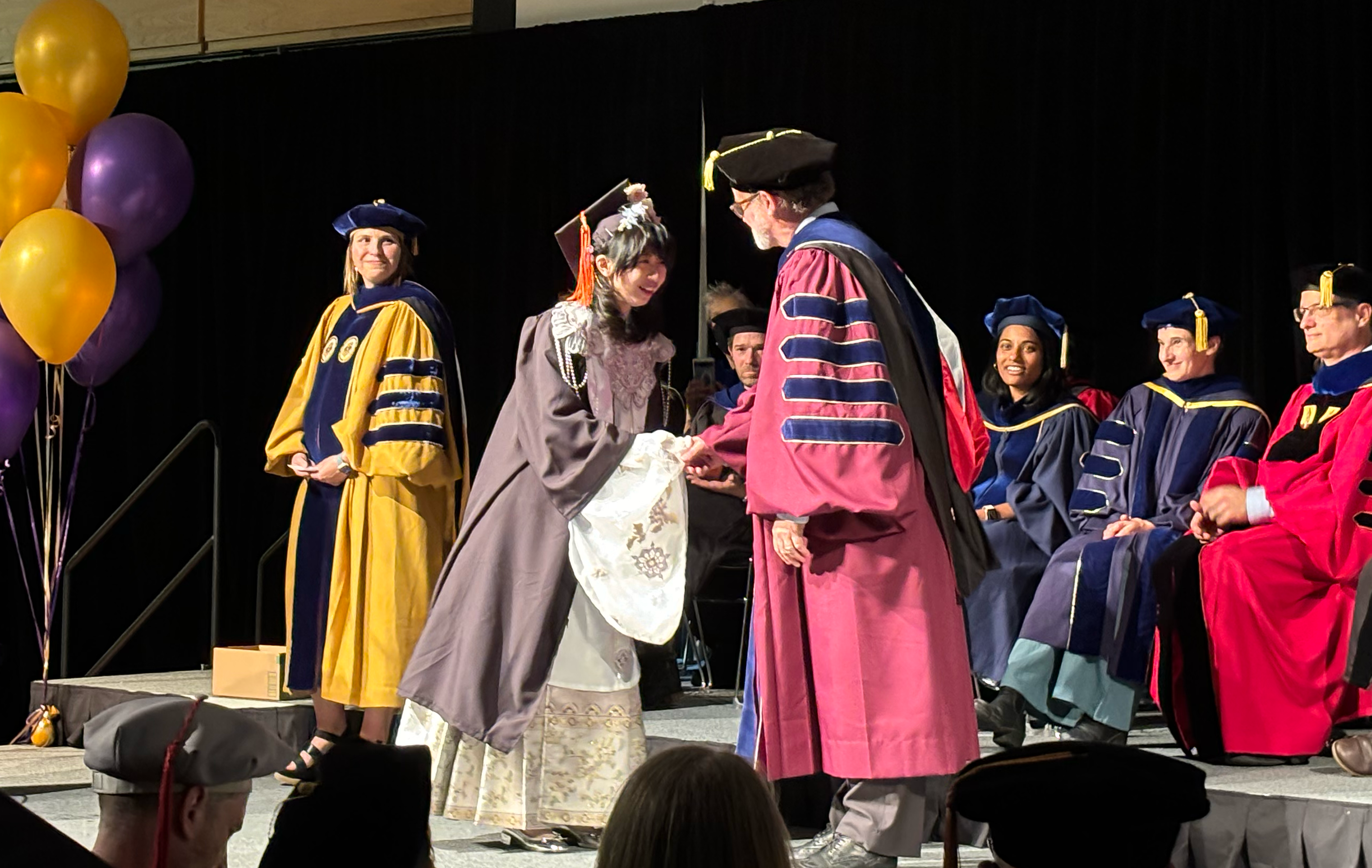 Graduates crossing the stage