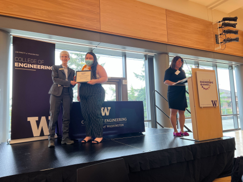 Dean Nancy Allbritton on stage with Alanna holding an award