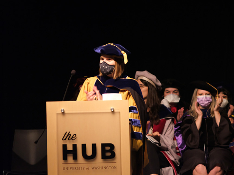Professor Julie Kientz behind the podium at the graduation ceremony