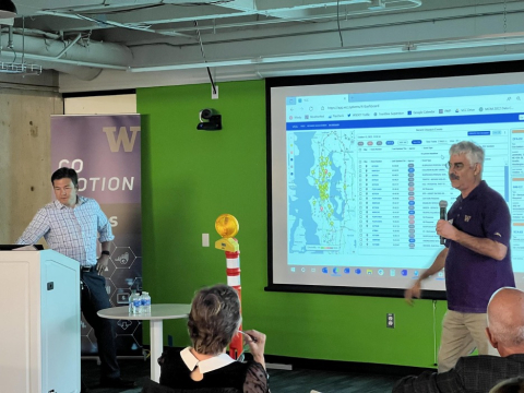 Mark Haselkorn presenting the VCC dashboard displayed on a projection screen to a room of people