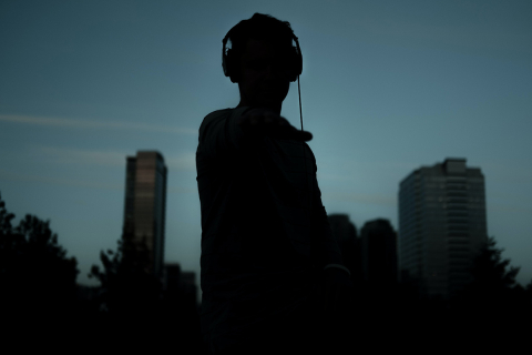 Silhouette of person wearing headphones