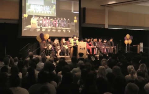 Professor Julie Kientz speaks from the podium in front of nearly 1,000 attendees at the 2023 HCDE graduation ceremony