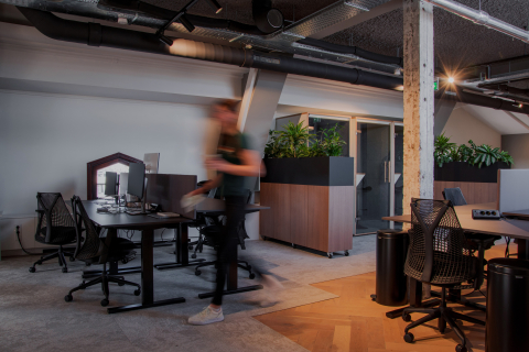 Blurry person walking in an otherwise empty office