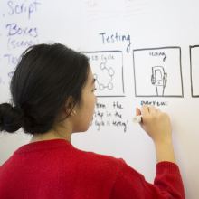 Student writing on white board
